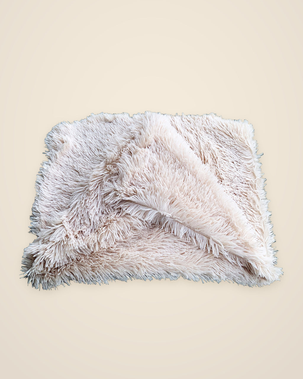 The DenKind Fluffy Blanket in beige, a long-pile double plush blanket, folded