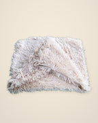 The DenKind Fluffy Blanket in beige, a long-pile double plush blanket, folded