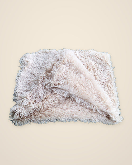 The DenKind Fluffy Blanket in beige, a long-pile double plush blanket, folded